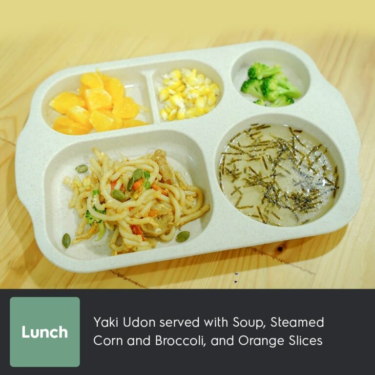 Yaki Udon served with Soup, Steamed Corn and Broccoli, and Orange Slices-min